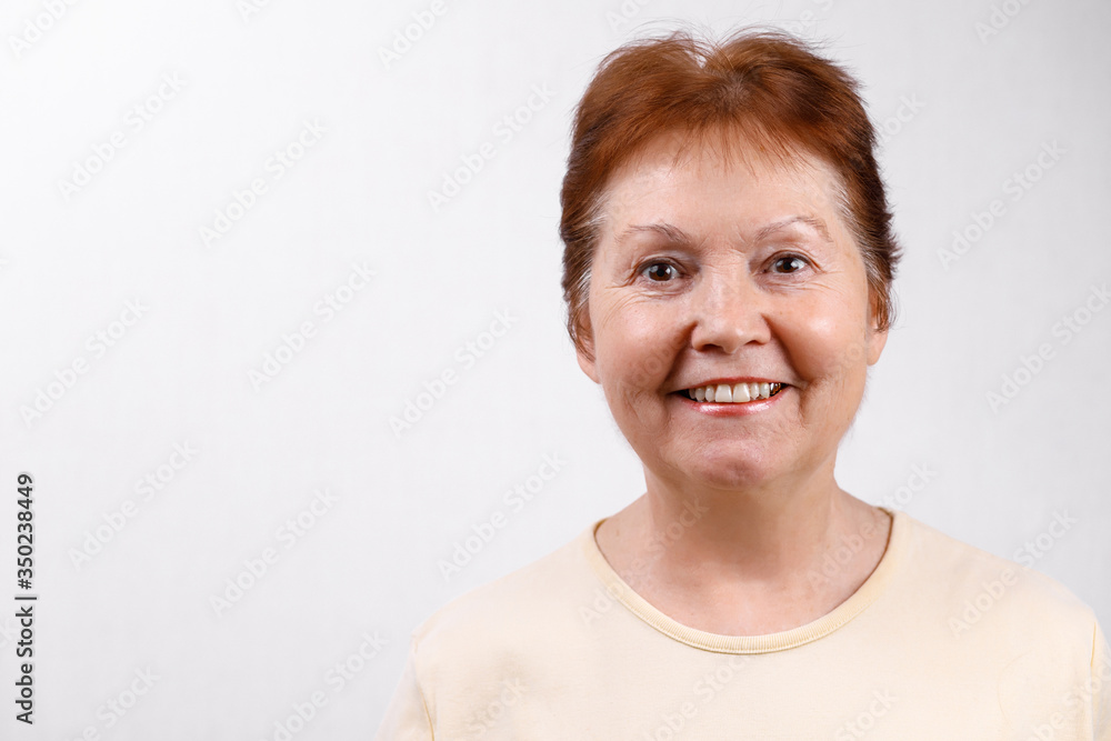 Adult woman on a white background in a light t-shirt. Emotions