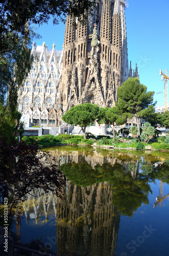 Building of Sagrada Familia of Barcelona from the park on a Sunny Day