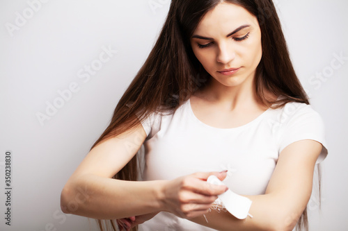 Young woman doing hair removal at home in the hands area