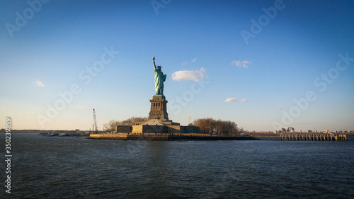 Sun rays blessing the Liberty statue in USA