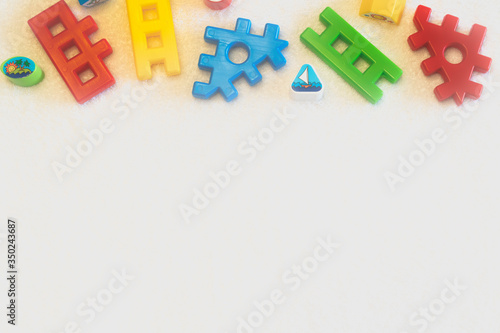 Foto Colorful tinker toys for toddler on white background with copy space