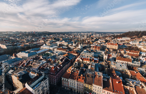 View of the old city and people from above, from the observation tower of the town hall. Lviv, Ukraine, winter panorama. Aerial view.