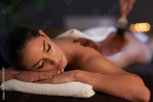 Relaxed woman receiving a chocolate back massage