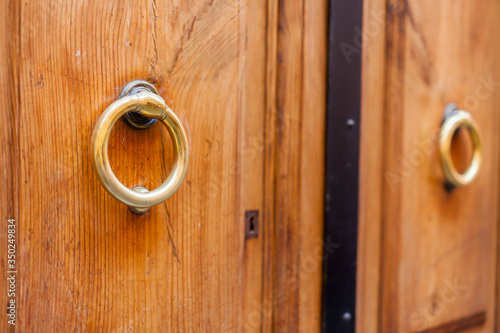 Fotografie Beautiful wooden door with ring knocker on the front door.