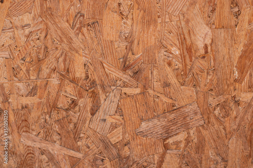 The brown particle board texture was shot close-up. There is a place for text.