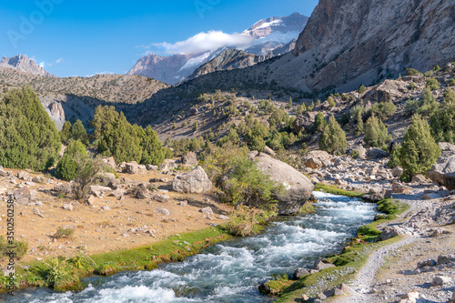 The beautiful mountain trekking road with clear blue sky and rocky hills in Fann mountains in Tajikistan