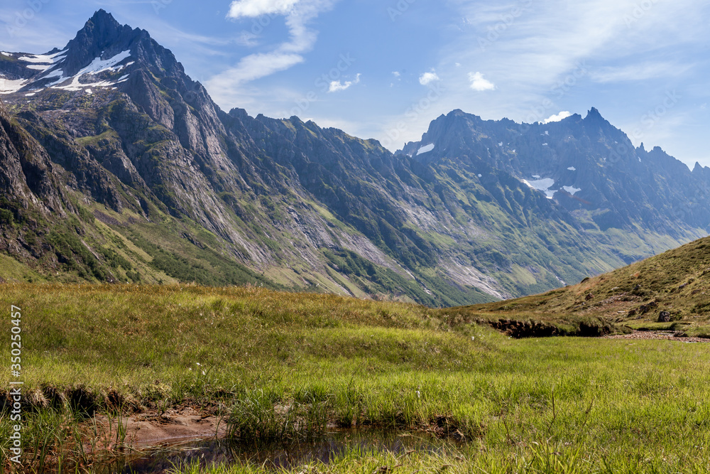 ROMEDALEN, NORWAY - 2014 JULY 21. Dreamy mountain valley with green forests, rocks and snow on top of the mountain. ROMEDALEN, NORWAY - 2014 JULY 21. Dreamy mountain valley with green forests, rocks and snow on top of the mountain.