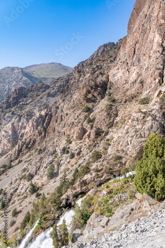 The beautiful mountain trekking road with clear blue sky and rocky hills in Fann mountains in Tajikistan