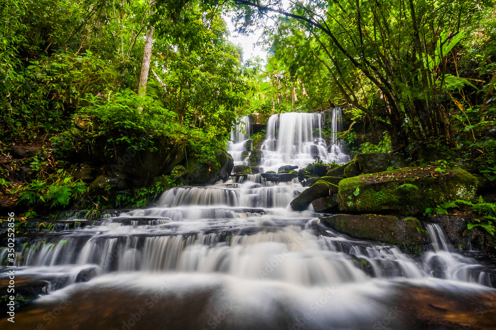 Beautiful nature rock waterfall steps. Waterfall in mountain valley with tropical rainforest at Mun Dang Waterfall, Phu Hin Rong Kla National Park, Phetchabun, Thailand.