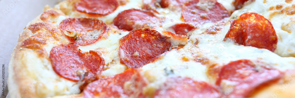 Fresh baked pizza with crusty cheese and hot tasty pepperoni ready to eat Fresh baked pizza with crusty cheese and hot tasty pepperoni ready to eat