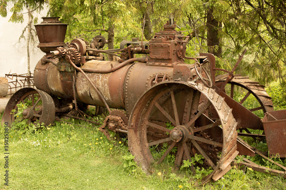 Old rusty machine near the trees