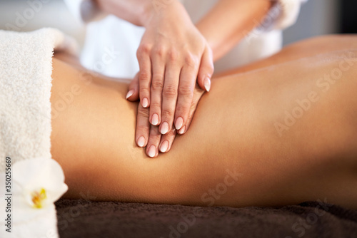 Relaxed woman receiving back massage
