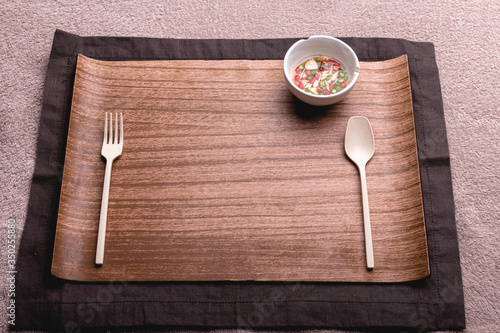 Wooden plate with spoon and fork