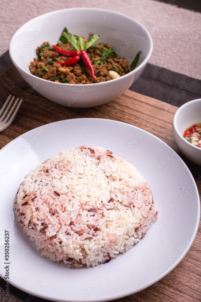 Stir fried minced pork with basil served with steamed jasmin rice and Riceberry, Pad kra pao. Stir fried minced pork with basil served with steamed jasmin rice and Riceberry, Pad kra pao.