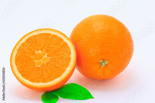 One orange fruit and half cut orange on white background 