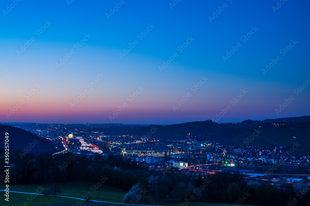 Germany, Day to night sunset and dawning over skyline of houses stuttgart in neckar valley from above