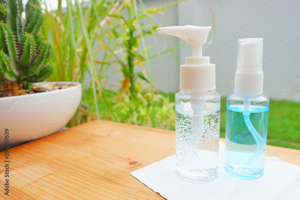 Alcohol gle and a white cloth on wood shelf.Alcohol gel bottle for protect bacterial and anti virus (COVID19).Close up. Alcohol gle and a white cloth on wood shelf.Alcohol gel bottle for protect bacterial and anti virus (COVID19).Close up.