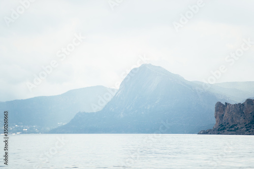 Landscape sea and mountains in the fog