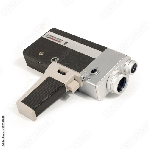 Vintage historic analog handheld filmmaker camera for super-8 films with viewfinder and handle grip. Full shot on white background with object shadow for cut out, no people.