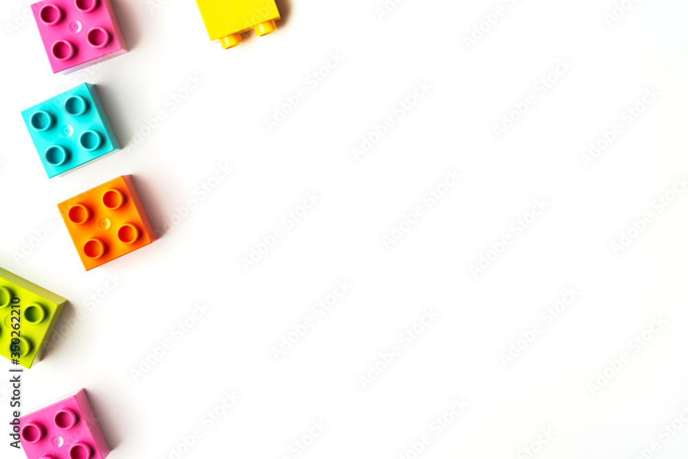Lot of colorful rainbow toy bricks background. Educational toy for children Isolated on white background. Top view with copy space Lot of colorful rainbow toy bricks background. Educational toy for children Isolated on white background. Top view with copy space
