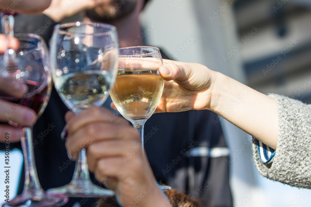 people cheers with glasses of vine