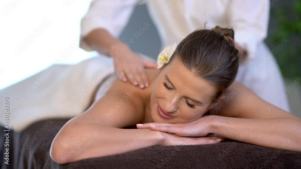 Woman enjoying body massage at spa club Woman enjoying body massage at spa club