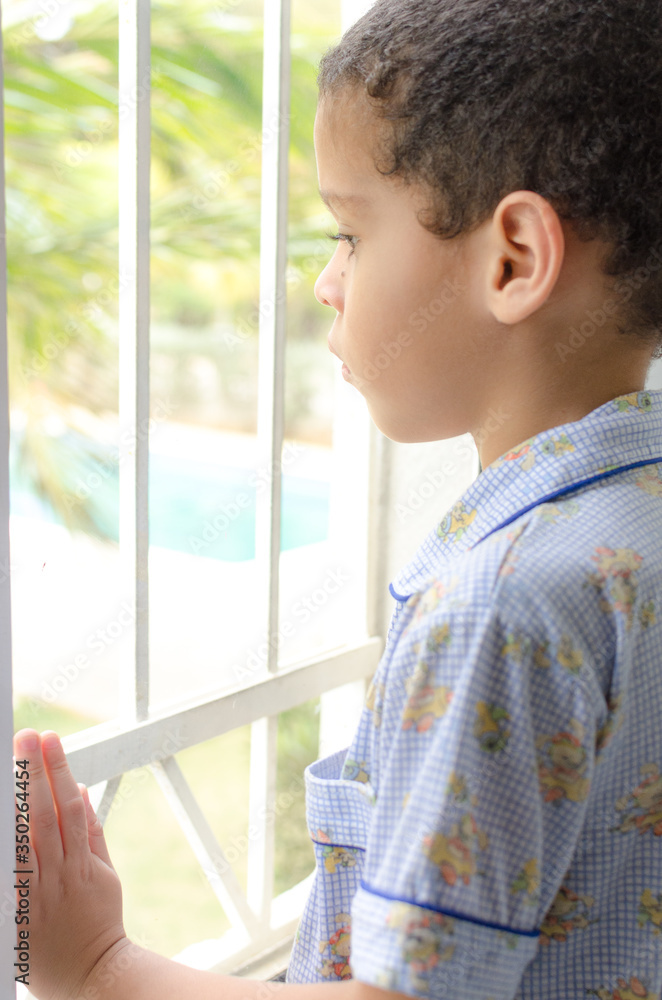 boy watching out of window boy watching out of window