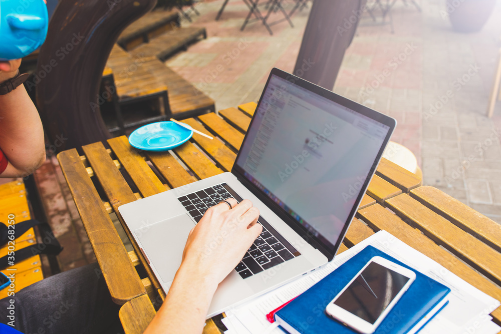 Man professional copywriter creating new promotional article while relaxing in coffee shop outdoors Man professional copywriter creating new promotional article while relaxing in coffee shop outdoors