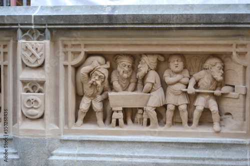 GERMANY, COLOGNE-2018: Bas-relief gnomes bakers knead dough and bake bread. Fragment of the dwarf fountain