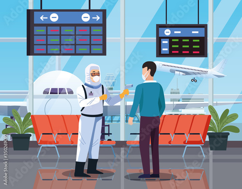 biosafety worker checking temperature in airport for covid19