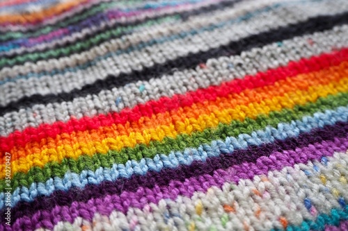 close up of rainbow hand knitting 
