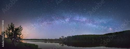 Panorama of the starry sky over the lake
