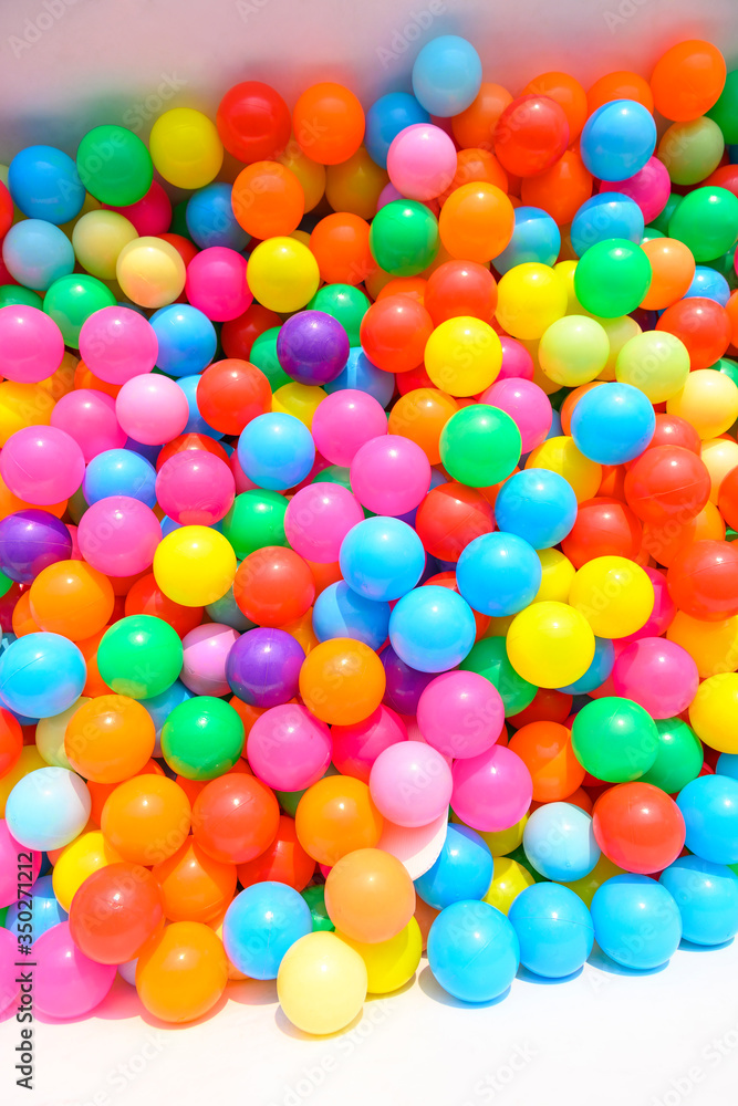 Small colorful plastic balls in playground yard Small colorful plastic balls in playground yard