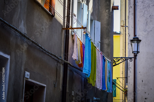 Washed clothes hanging outside the windows in the street of Chioggia, near Venice in Italy.
