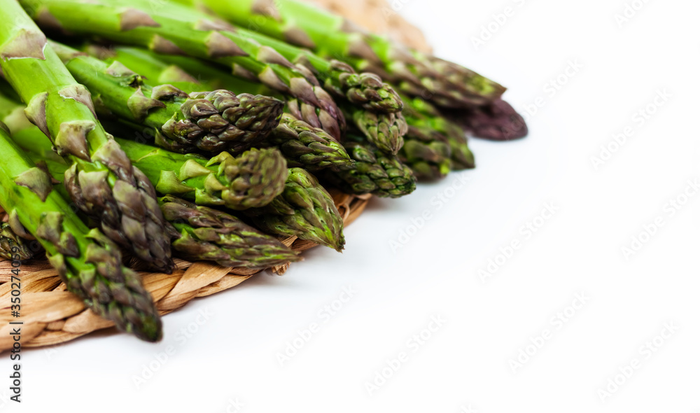 Bunch of fresh raw asparagus on white background, vegetarian concept. Green grass sparrowgrass sticks, food for veggie. Bunch of fresh raw asparagus on white background, vegetarian concept. Green grass sparrowgrass sticks, food for veggie.