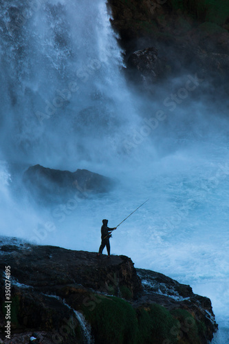 Fisherman fishing in storm