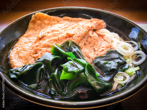 Close up of juicy Kitsune & Wakame Udon in local restaurant. photo