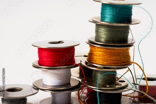                                Industrial Sewing machine bobbins isolated on white background arranged in abstract and random order neat colorful playful