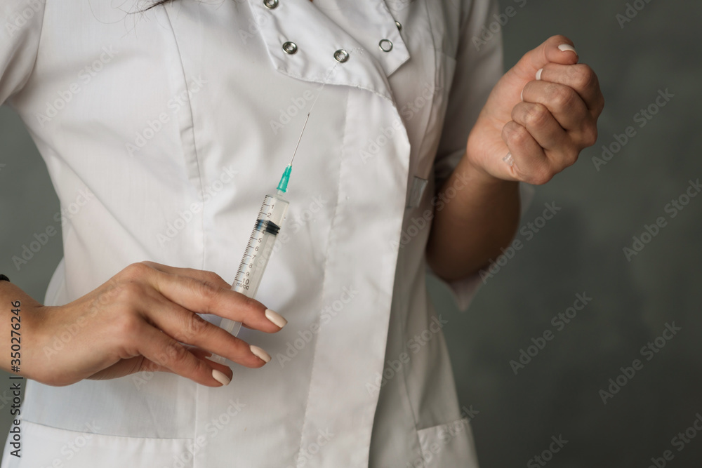 syringe in the hands of a nurse in a white coat syringe in the hands of a nurse in a white coat