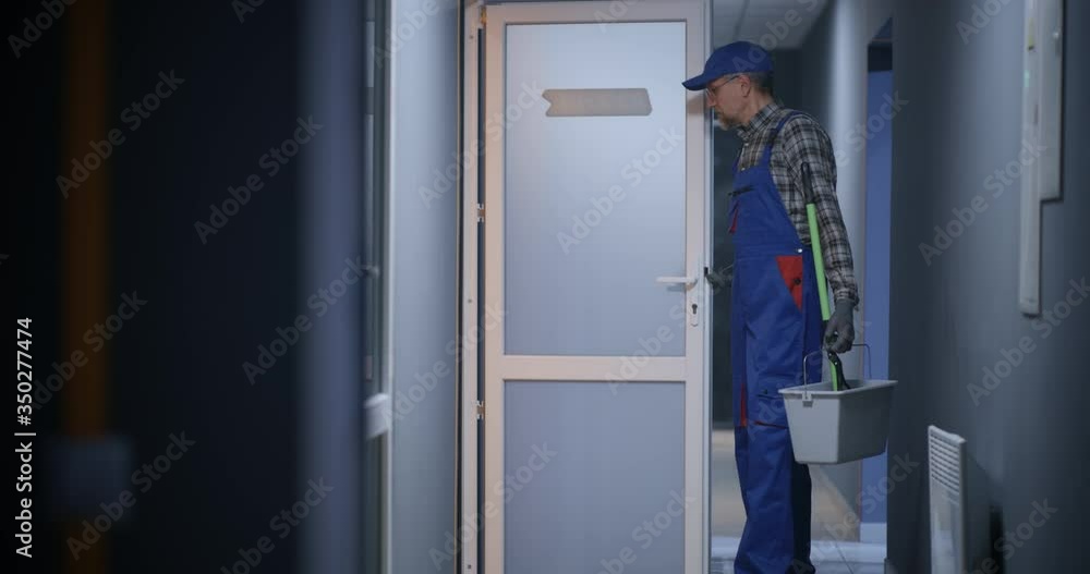 Janitor cleaning a corridor Janitor cleaning a corridor