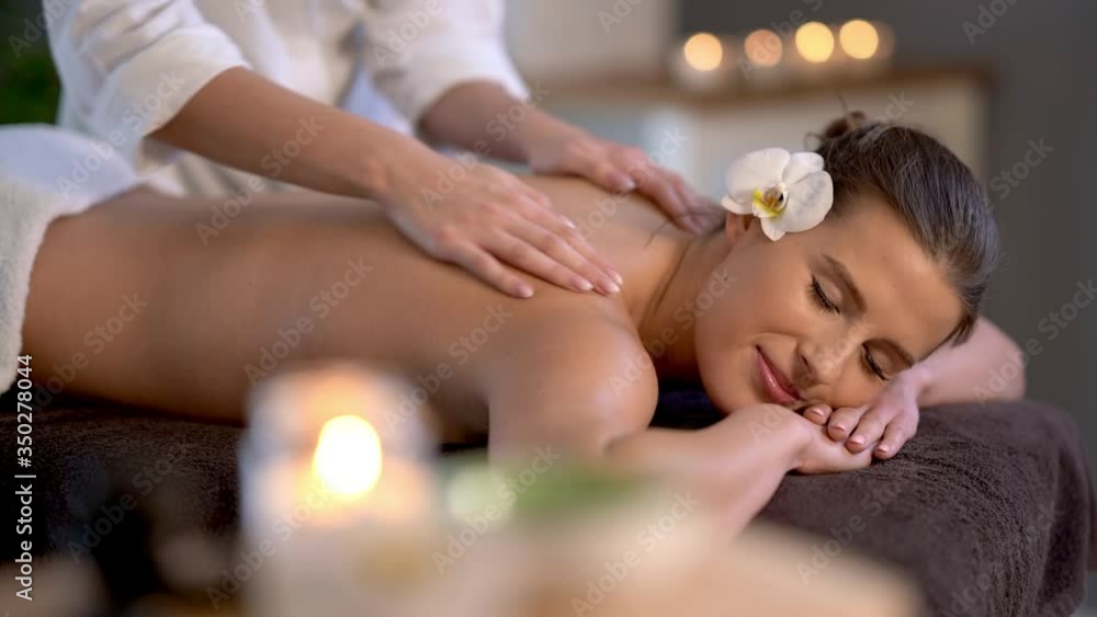 Woman enjoying body massage at spa club Woman enjoying body massage at spa club