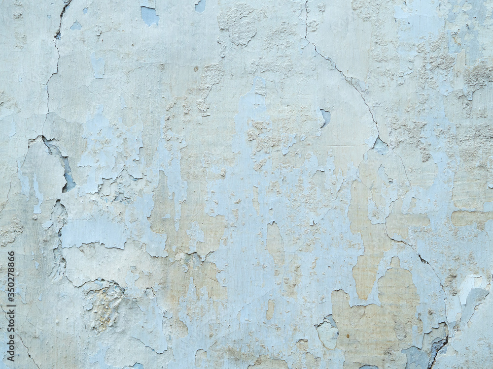 texture of old stucco on the wall. the white and blue plaster is applied unevenly, peeling off. old rough with cracks. texture of old stucco on the wall. the white and blue plaster is applied unevenly, peeling off. old rough with cracks.