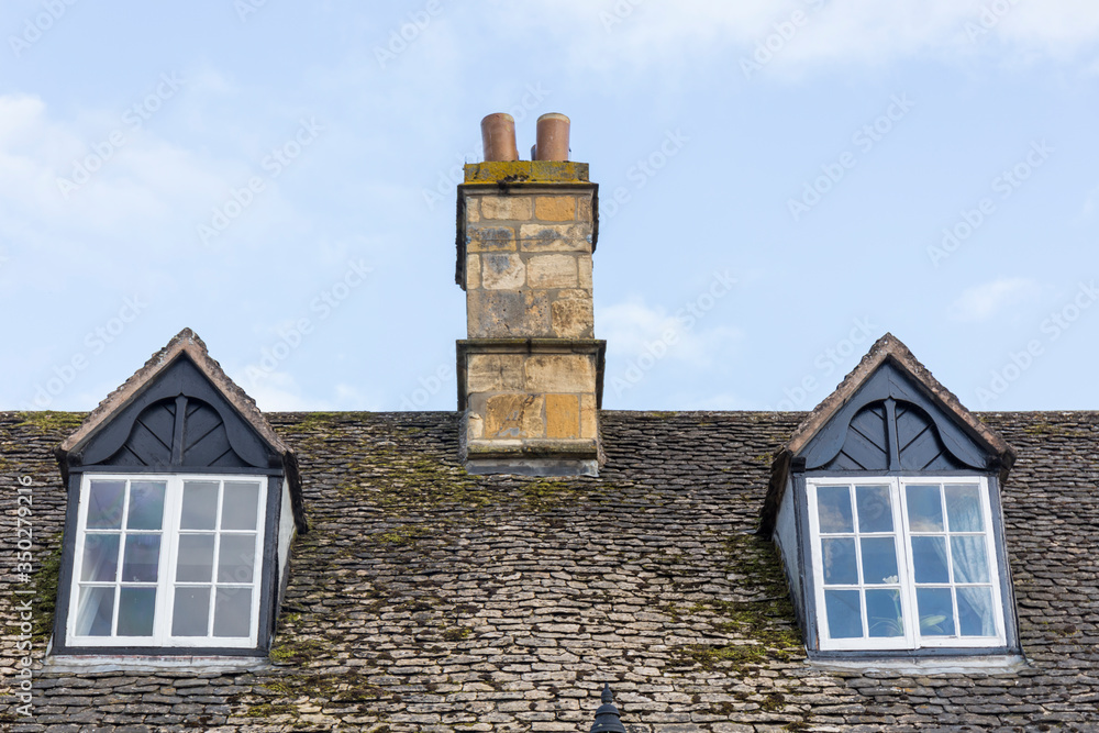 stone roof with large windows and a chimney of a cottage stone roof with large windows and a chimney of a cottage