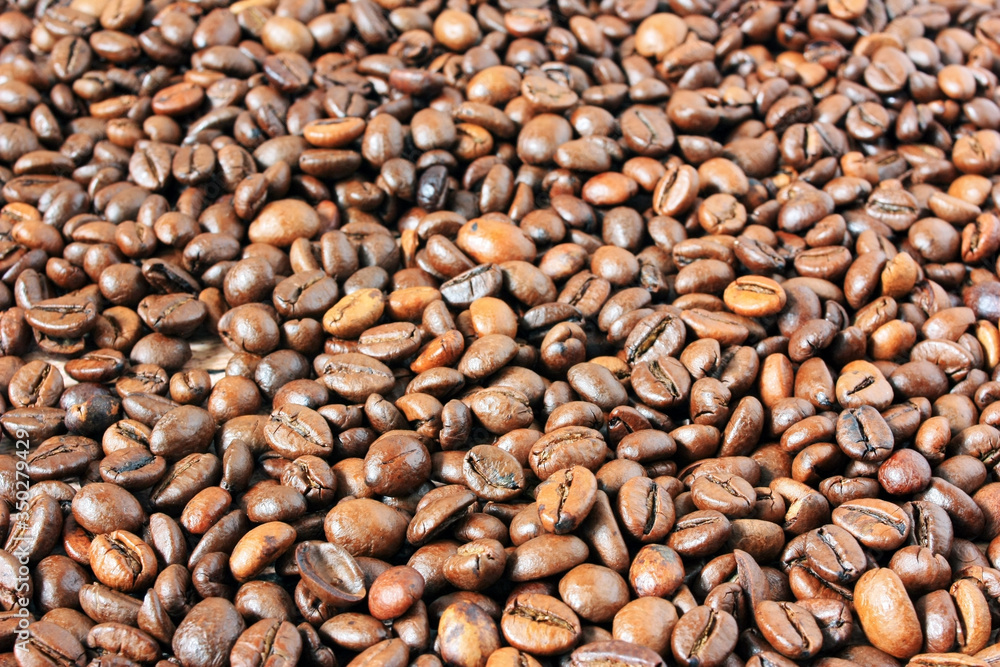 Coffee beans scattered on the table Coffee beans scattered on the table