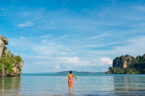 Woman enjoying freedom and leisure at beautiful Railay Beach, Thailand.