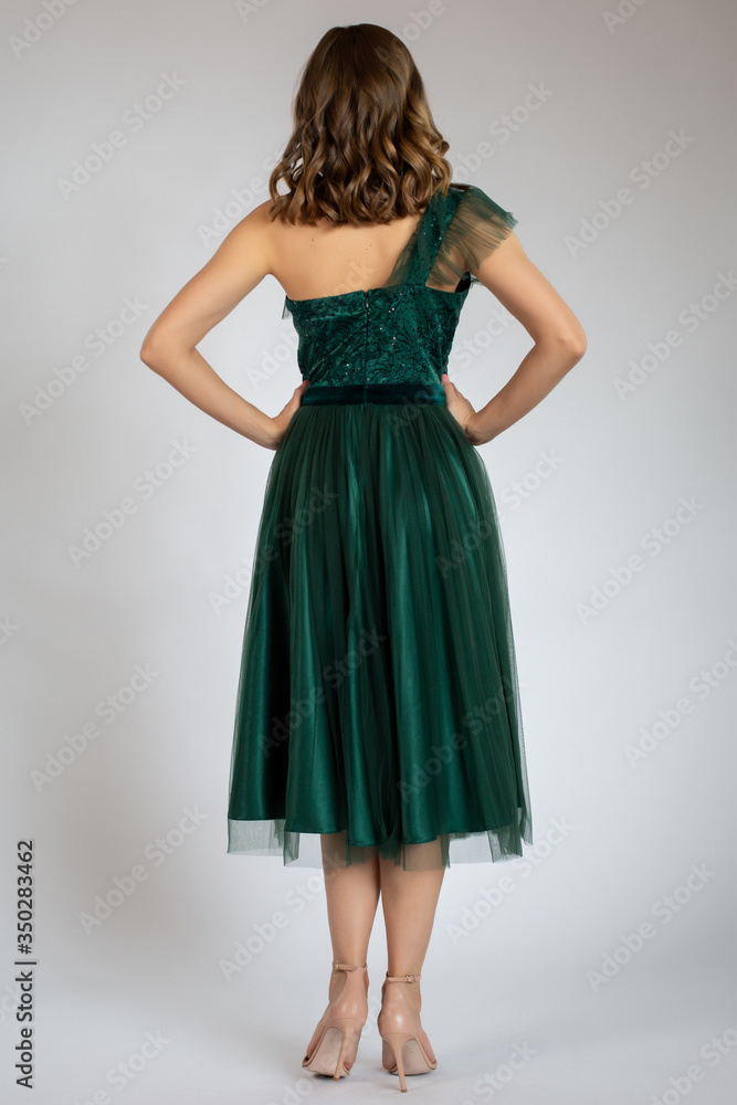 Beautiful girl posing in green dress