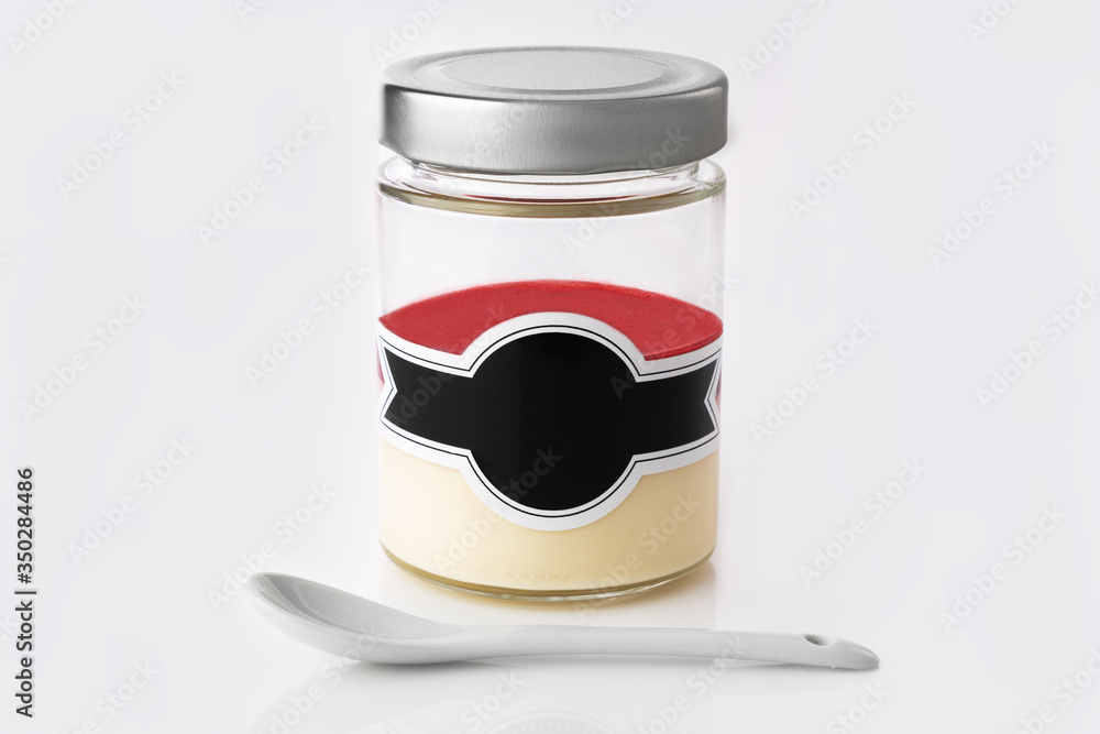Milky dessert with cream and fruity jelly in a jar isolated on white background Milky dessert with cream and fruity jelly in a jar isolated on white background
