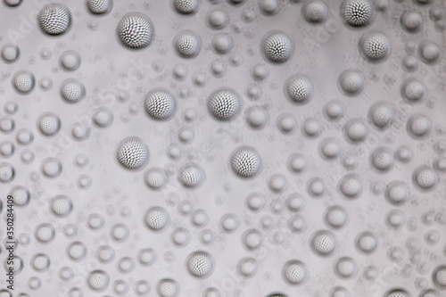 Abstract lines through drops of water on a glass  macro view