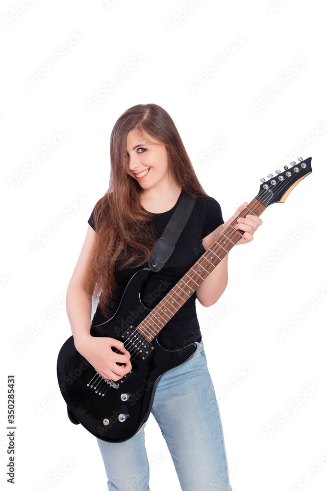 Attractive, young woman with long hair in blue jeans and a black t-shirt plays an electric guitar isolated on a white background. Attractive, young woman with long hair in blue jeans and a black t-shirt plays an electric guitar isolated on a white background.