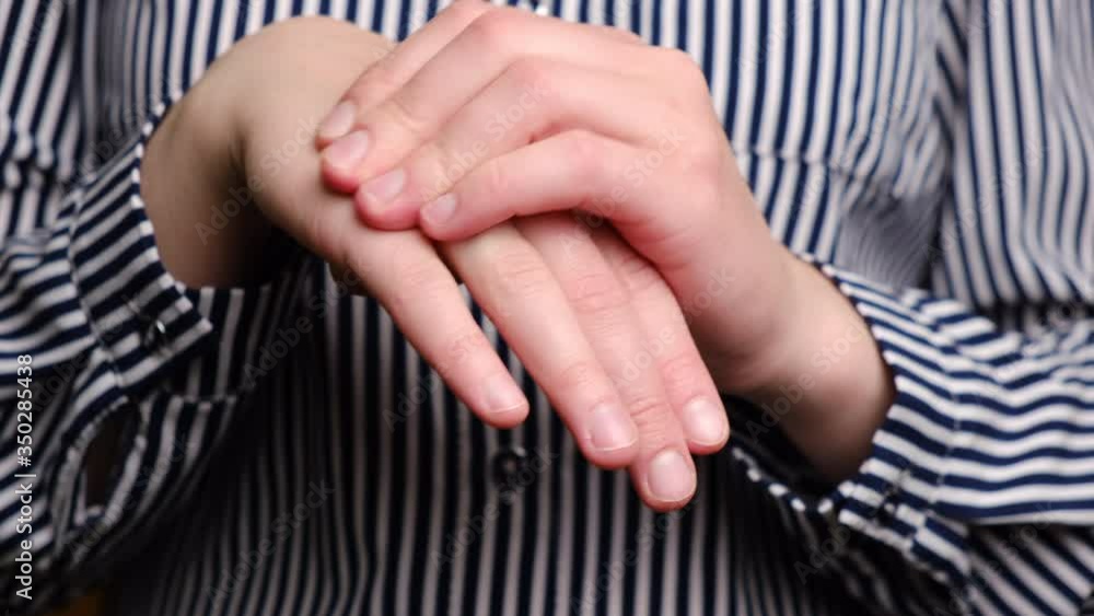 Closeup of female arms holding her painful wrist caused by prolonged